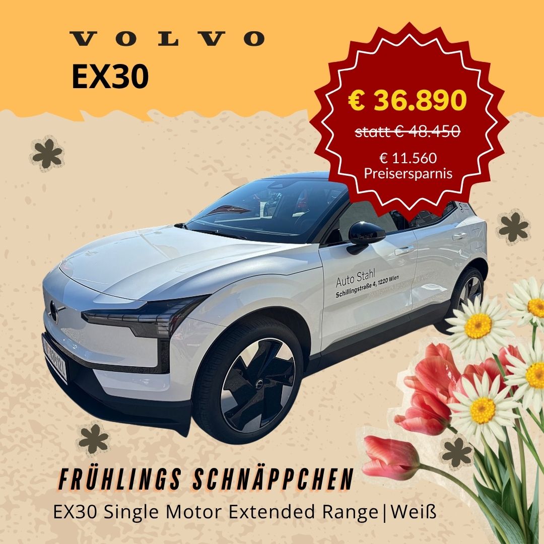 Weißes Auto mit rotem Etikett und Blumen